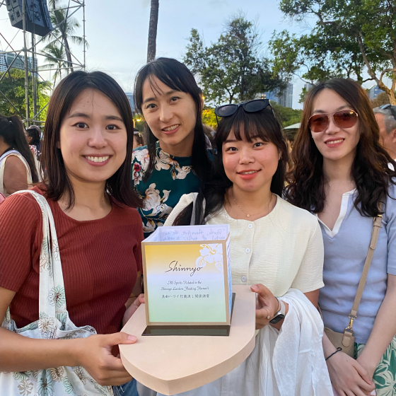 Yuan on the far right with three friends at a conference. 